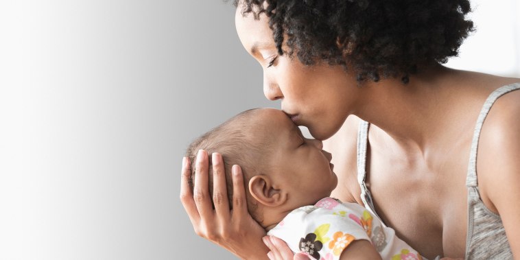 Image: Mother playing with baby indoors